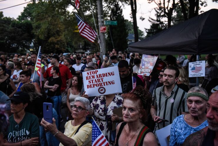 Demonstrators rally at protest against the opening of a temporary shelter for migrants in Staten Island.